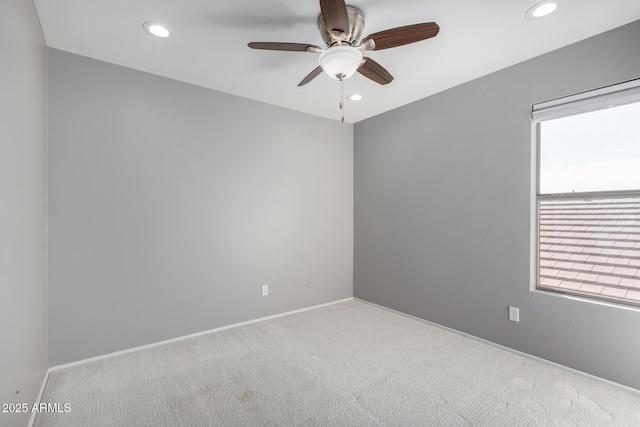 spare room with carpet and ceiling fan