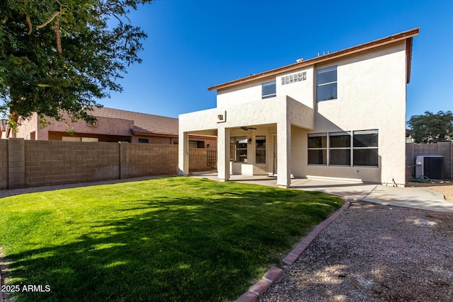 back of house featuring ceiling fan, central air condition unit, a patio, and a lawn