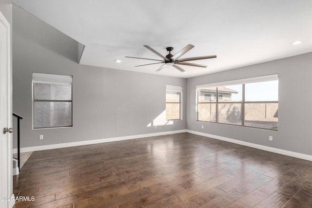 empty room featuring ceiling fan and dark hardwood / wood-style floors