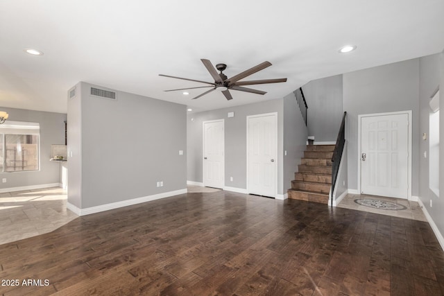 unfurnished living room featuring dark hardwood / wood-style floors and ceiling fan