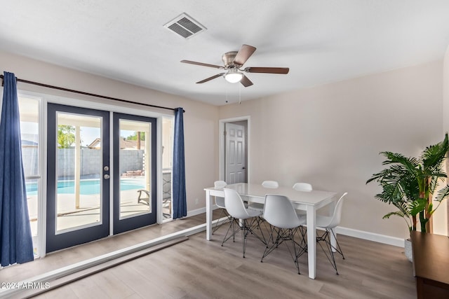 dining space featuring french doors, ceiling fan, and wood-type flooring