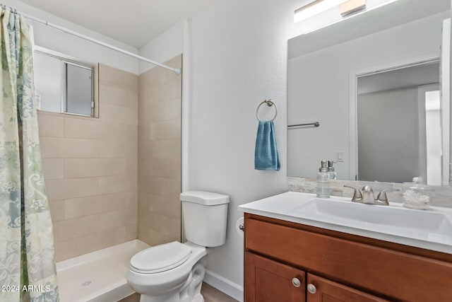 bathroom with vanity, walk in shower, and toilet