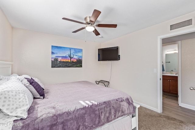 bedroom featuring sink, ensuite bathroom, ceiling fan, and carpet flooring