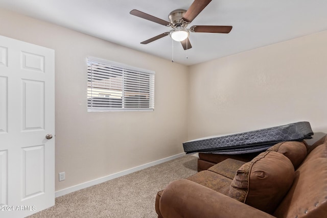 sitting room featuring light colored carpet and ceiling fan