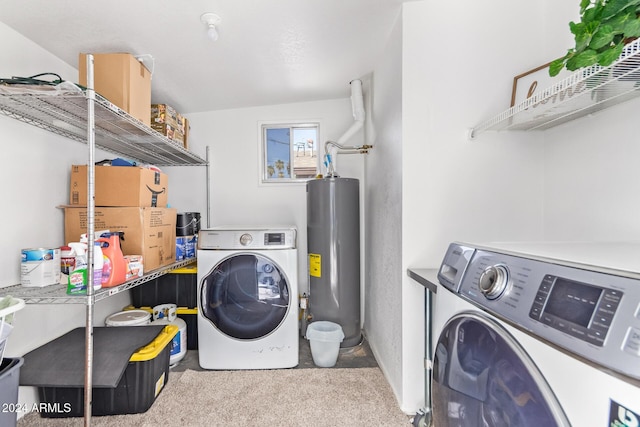 laundry area featuring gas water heater, light colored carpet, and washing machine and clothes dryer