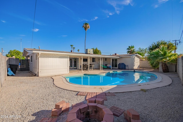 view of swimming pool with a patio area and an outdoor fire pit