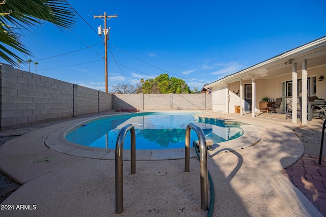 view of swimming pool featuring a patio area