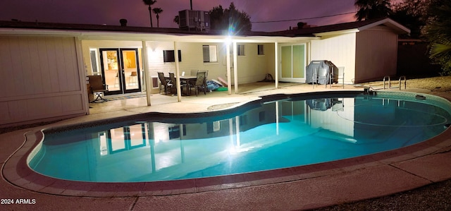 view of pool featuring central AC and a patio