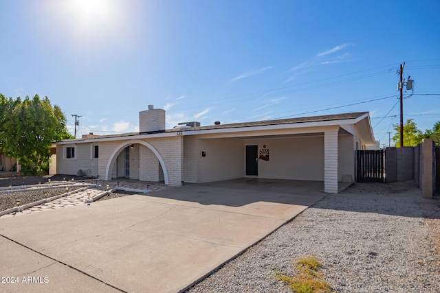 back of property featuring a carport