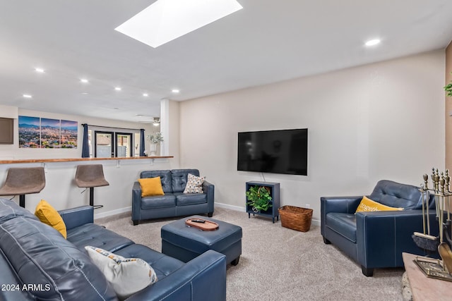 living room with light carpet and a skylight