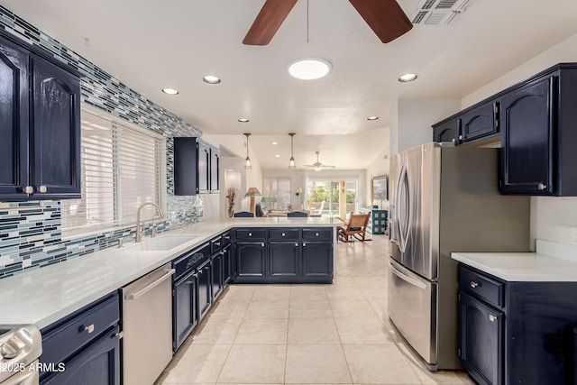 kitchen featuring light tile patterned floors, stainless steel appliances, visible vents, a sink, and a peninsula