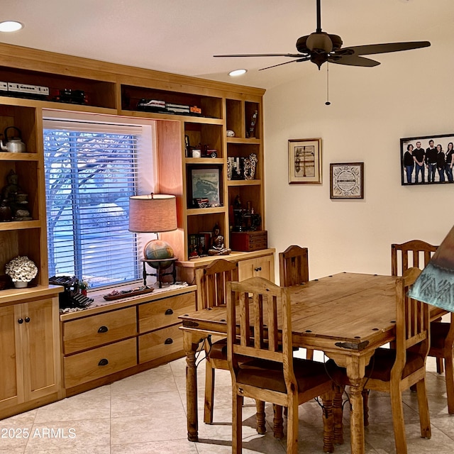 dining space with a ceiling fan and light tile patterned flooring