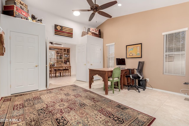 office area featuring ceiling fan, light tile patterned floors, vaulted ceiling, and baseboards