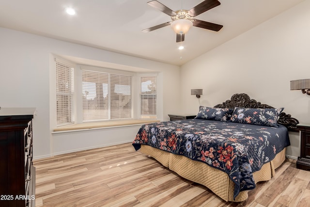 bedroom with lofted ceiling, light wood finished floors, recessed lighting, and baseboards