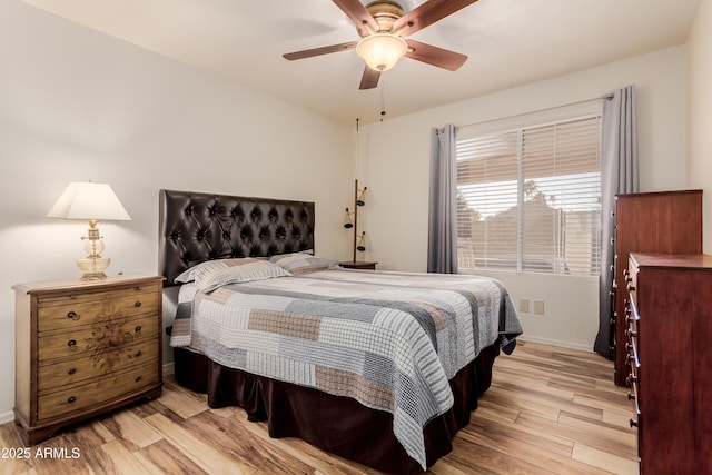 bedroom with light wood-type flooring, ceiling fan, and baseboards