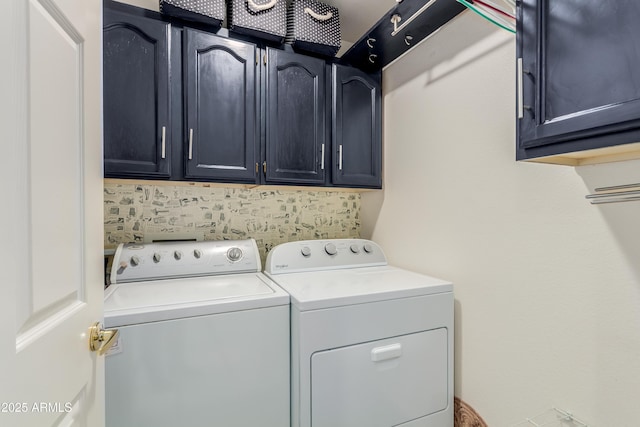 washroom featuring cabinet space and washing machine and dryer