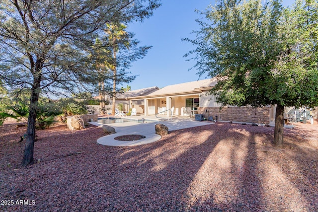 view of yard with an outdoor fire pit and a patio area