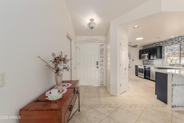 entryway featuring light tile patterned floors, ceiling fan, and recessed lighting