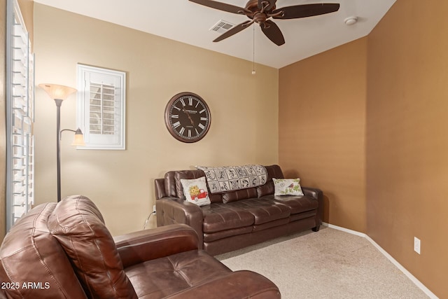 living room with ceiling fan and carpet