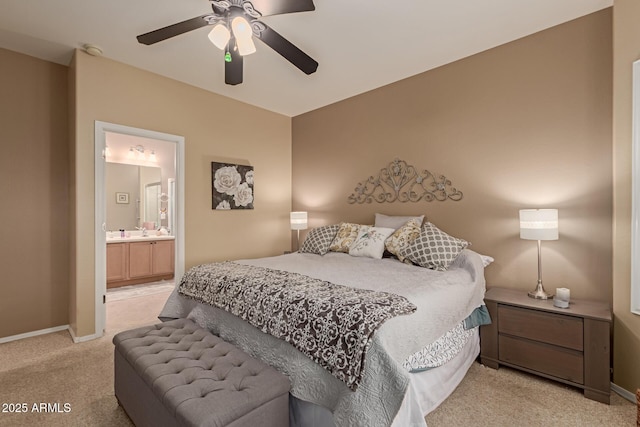 carpeted bedroom with ceiling fan and ensuite bath