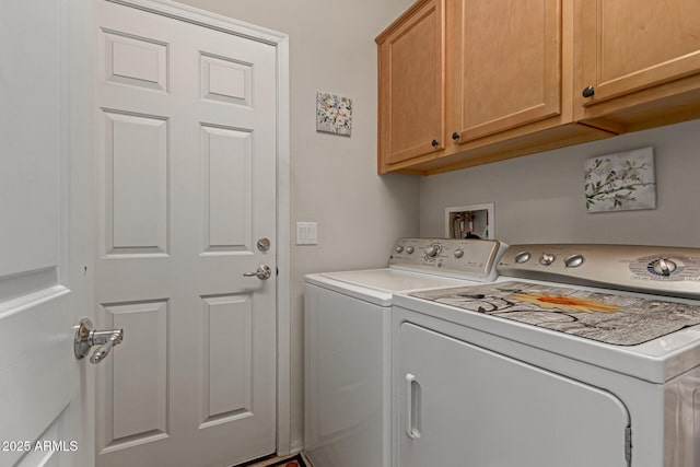 washroom with cabinets and washing machine and dryer