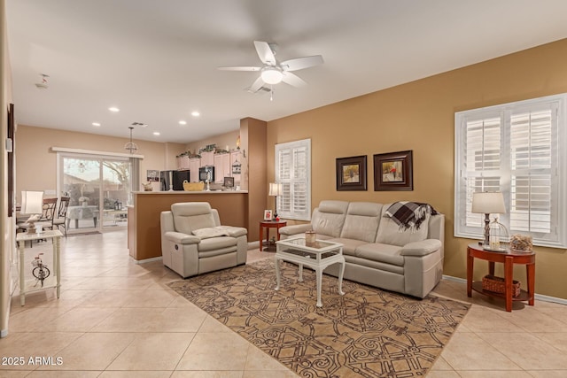 tiled living room with ceiling fan