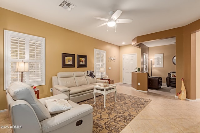 tiled living room featuring ceiling fan