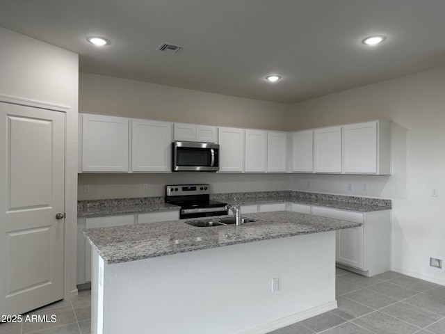 kitchen featuring an island with sink, appliances with stainless steel finishes, sink, and white cabinets