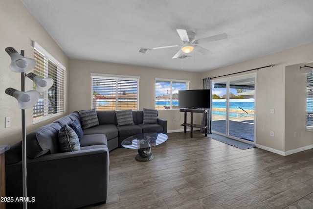 living room featuring a textured ceiling, ceiling fan, and hardwood / wood-style flooring