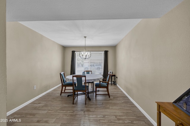 dining space with a chandelier and hardwood / wood-style floors