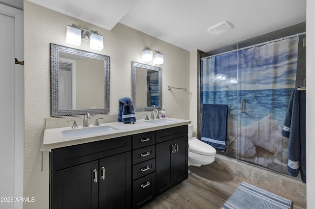 bathroom with toilet, a shower with curtain, hardwood / wood-style floors, and vanity