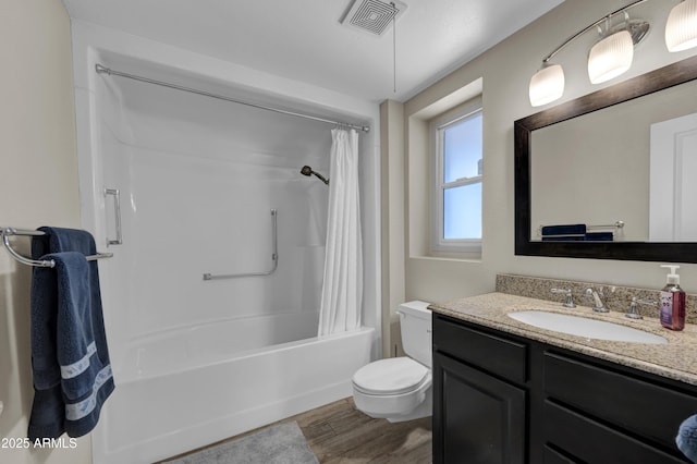 full bathroom featuring toilet, hardwood / wood-style flooring, shower / bathtub combination with curtain, and vanity