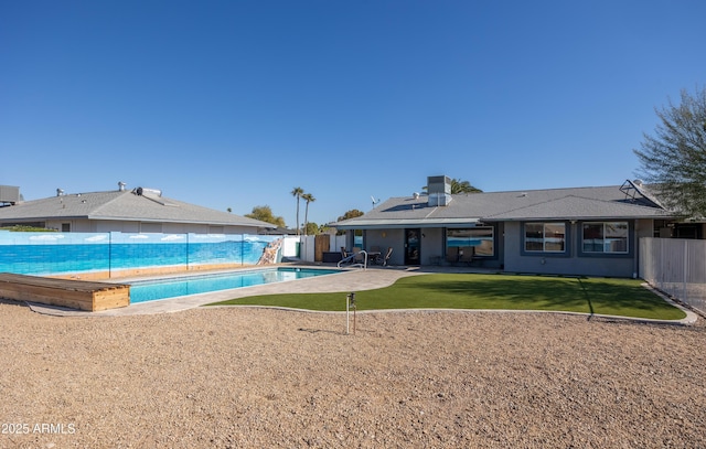 view of pool featuring a patio area and a yard