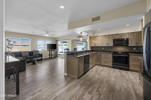 kitchen with tasteful backsplash, light hardwood / wood-style flooring, kitchen peninsula, electric stove, and dishwashing machine