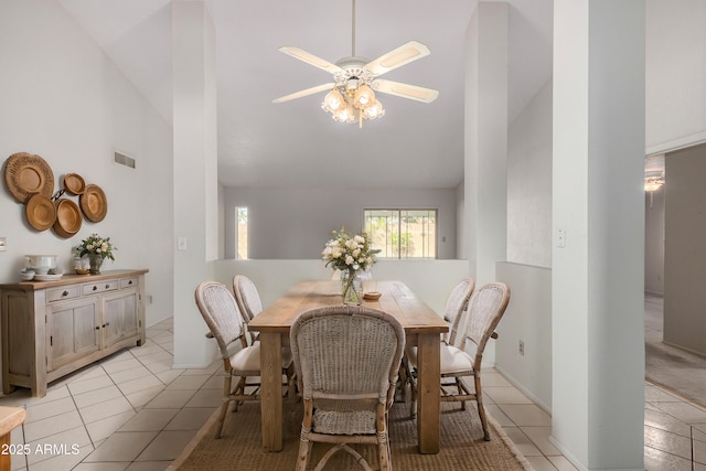 dining area featuring light tile patterned floors, ceiling fan, high vaulted ceiling, and visible vents