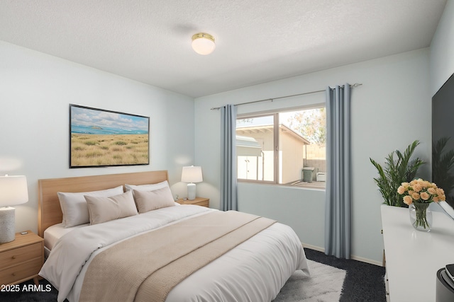 bedroom featuring a textured ceiling, carpet flooring, and baseboards