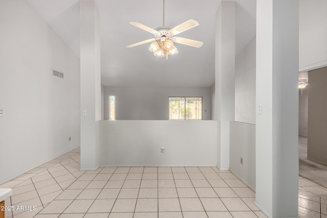 unfurnished room featuring a ceiling fan, lofted ceiling, visible vents, and light tile patterned flooring