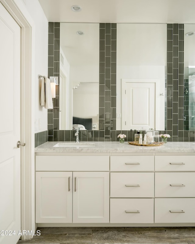 bathroom with hardwood / wood-style floors and vanity