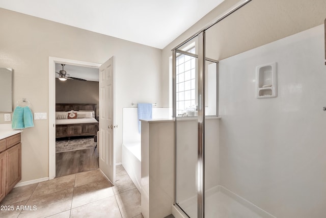 full bath featuring vanity, a garden tub, a stall shower, tile patterned floors, and ensuite bath