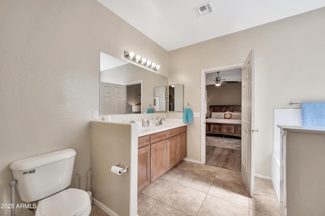 bathroom featuring tile patterned flooring, visible vents, connected bathroom, toilet, and vanity