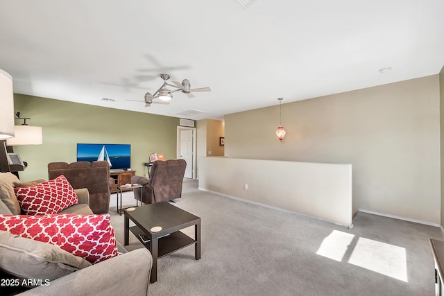 carpeted living area with visible vents, a ceiling fan, and baseboards