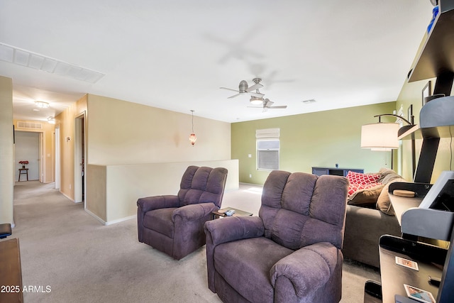 living room featuring baseboards, visible vents, carpet floors, and ceiling fan