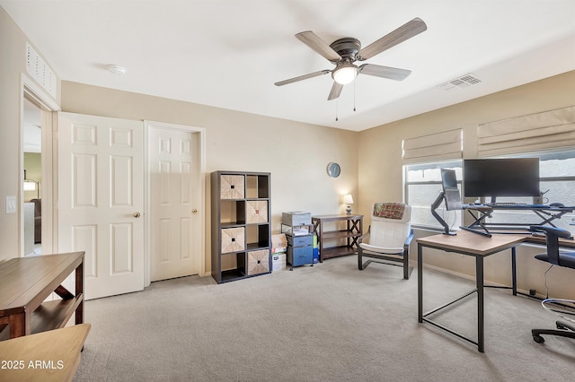 carpeted home office featuring visible vents and ceiling fan