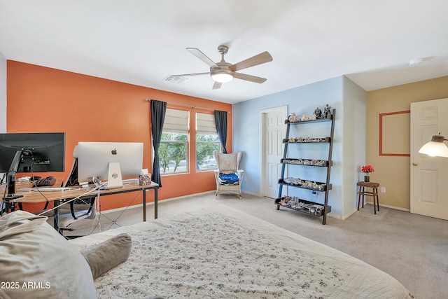 carpeted office with visible vents, baseboards, and ceiling fan