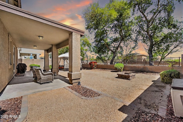 view of patio / terrace with an outdoor living space with a fire pit and a fenced backyard