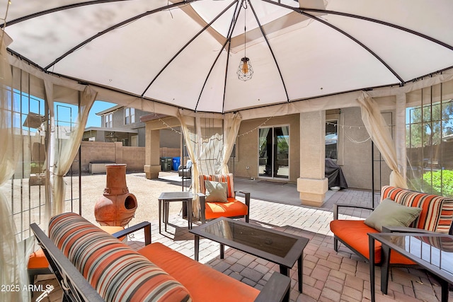 view of patio featuring fence and an outdoor hangout area