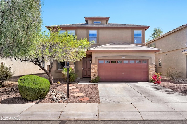 american foursquare style home featuring a garage, stone siding, driveway, and stucco siding