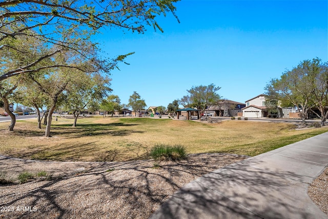 view of yard with a garage and a residential view