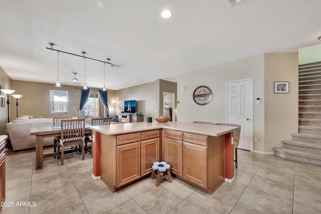 kitchen featuring light countertops, light tile patterned flooring, and open floor plan