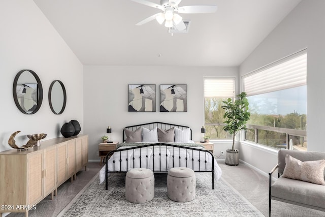 carpeted bedroom with multiple windows, ceiling fan, and vaulted ceiling